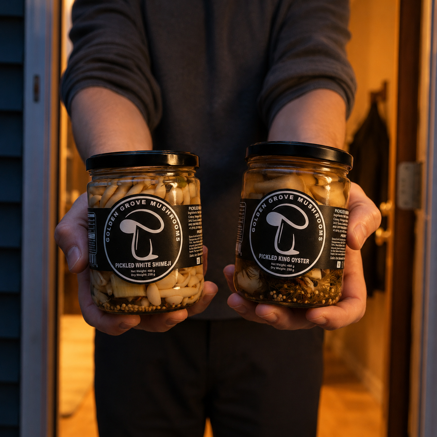 Two jars of pickled mushrooms held out at a doorway at dusk