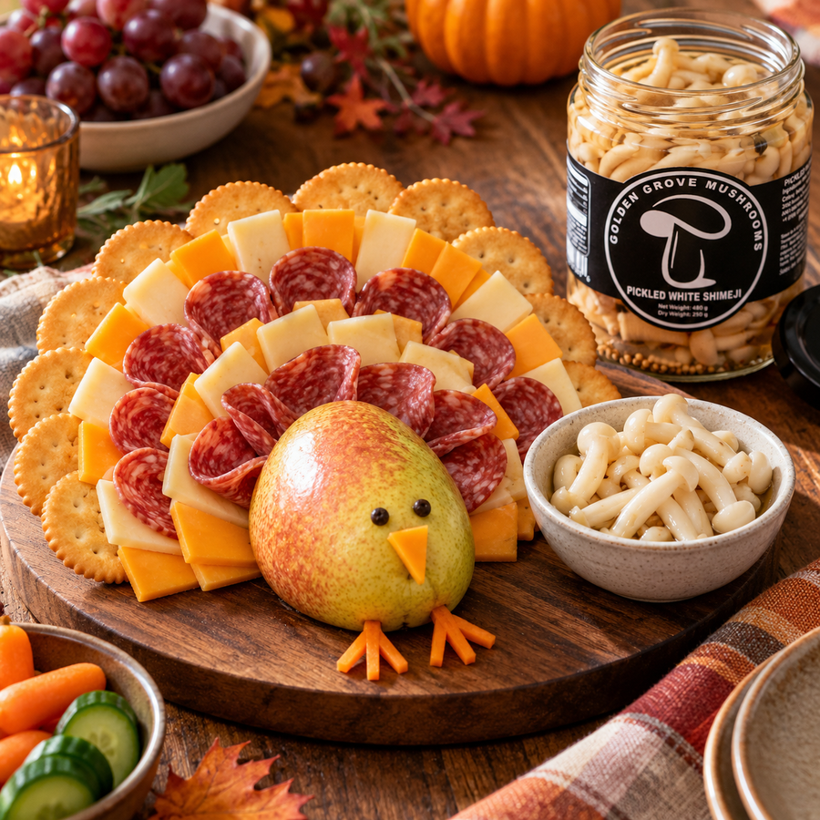 A turkey-shaped Thanksgiving board with a pear body and fanned rows of crackers, cheese and salami for the tail feathers