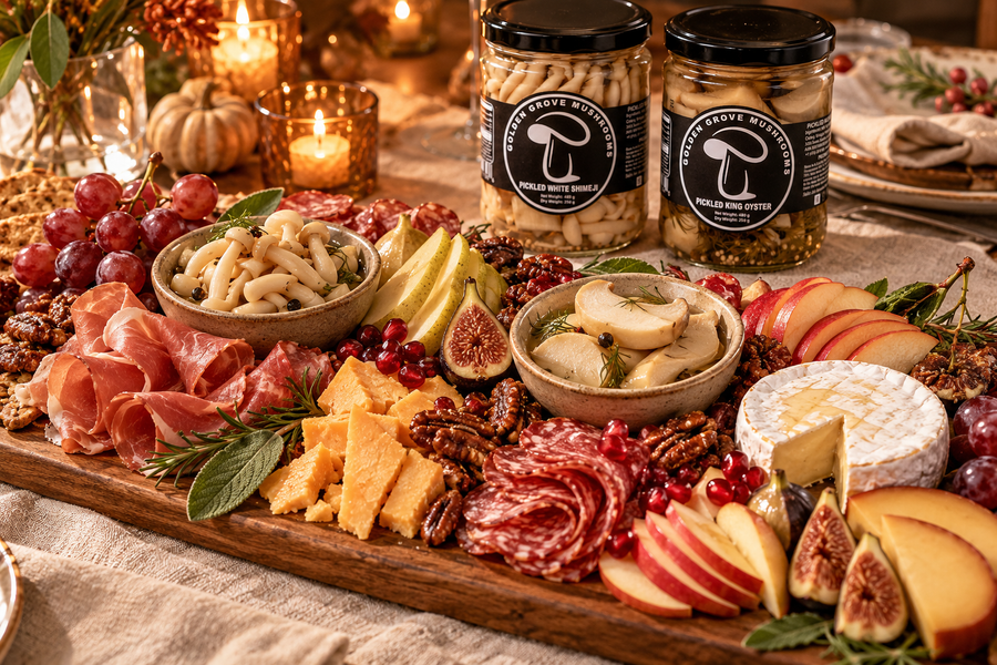A Thanksgiving charcuterie board with cheeses, pears, figs, pecans and sage, and small bowls of pickled white shimeji and king oyster