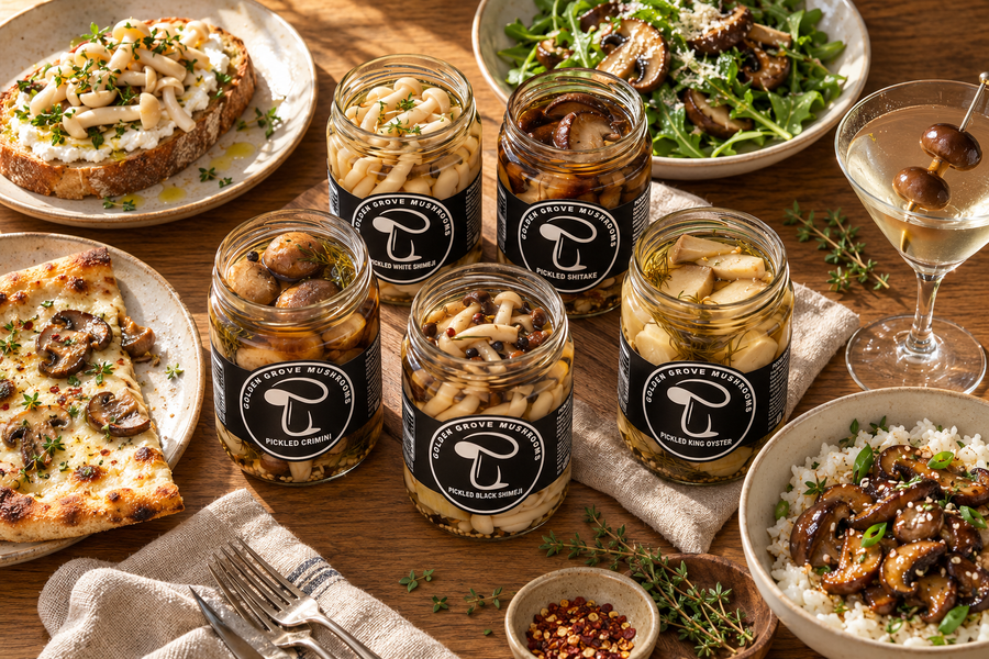 Five open jars of pickled mushrooms surrounded by ricotta toast, a salad, a pizza and a martini